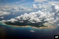 FILE - Clouds hang over the North Sentinel Island, in India's southeastern Andaman and Nicobar Islands.