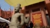 FILE PHOTO - The head of Male Divinity statue, right, and other artifacts are on display during a ceremony after the artifacts were returned back from Norwegian collector Morten Bosterud, at Cambodian National Museum in Phnom Penh, Cambodia, Tuesday, Oct. 20, 2015. 