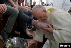 Pope Francis kisses a foot of an inmate during the celebrations of the Holy Thursday at the District House of Velletri prison, in Velletri near Rome, Italy, April 18, 2019.
