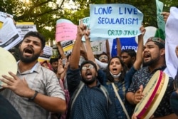 Activists of All India Students Association (AISA) and other student’s unions shout slogans against recent incidents of violence in Tripura state, during a protest in New Delhi, India, Oct. 29, 2021.