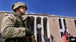 FILE - US marine guards entrance of American embassy in Kabul, Afghanistan.