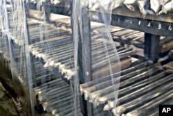 FILE - Unused nuclear fuel rods are piled on the shelves of a warehouse at North Korea's main nuclear plant in Yongbyon, North Korea.