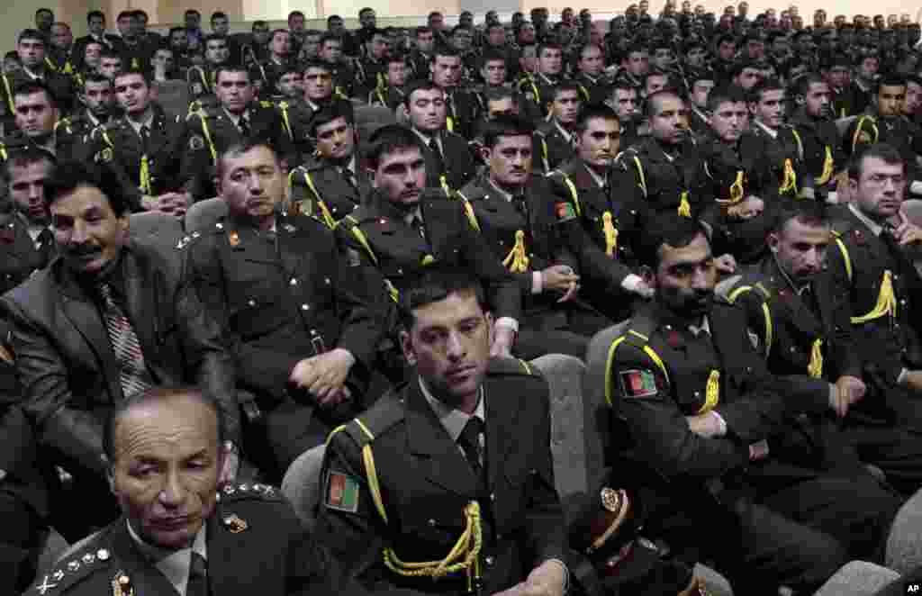Afghan security officials attend a handover ceremony at a military academy on the outskirts of Kabul, June 18, 2013.