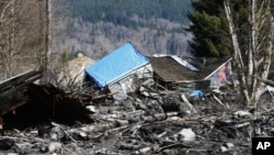 A house is seen destroyed by mud on Highway 530 next to mile marker 37, in Washington state, March 23, 2014.