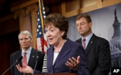 FILE - Sen. Susan Collins, R-Maine, center, flanked by Sen. Dean Heller, R-Nev., right, and Sen. Rob Portman, R-Ohio, left, on Capitol Hill, Washington.