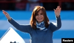 FILE - Former Argentine President Cristina Fernandez de Kirchner waves during a rally in Buenos Aires, June 20, 2017.