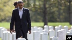 President Barack Obama and first lady Michelle Obama, visit Section 60 at Arlington National Cemetery, Saturday, Sept. 10, 2011, in Arlington, Va., to pay their respects to those who have made the ultimate sacrifice in the past decade.