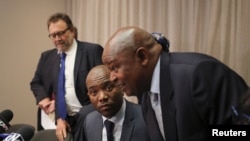 Leader of South Africa's Democratic Alliance (DA) Mmusi Maimane looks on next to Congress of the People (COPE) leader Mosiuoa Lekota, ahead of a media briefing in Sandton, South Africa August 17,2016.
