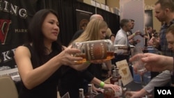 Representatives of distillers pour whiskey at the WhiskyFest in Washington, D.C.