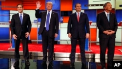 FILE - Republican presidential candidates, Sen. Marco Rubio, businessman Donald Trump, Sen. Ted Cruz, and Ohio Gov. John Kasich take the stage before a Republican presidential primary debate at Fox Theatre in Detroit, March 3, 2016.