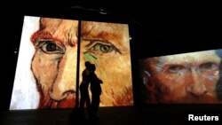 FILE - People visit the Van Gogh Alive exhibition in St. Petersburg, Sept. 11, 2014.