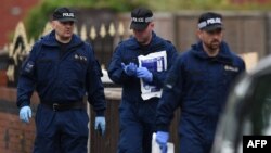 FILE - Police officers arrive at a residential property on Elsmore Road in Fallowfield, Manchester, on May 24, 2017, as investigations continue into the May 22 terror attack at the Manchester Arena.