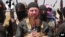 FILE - Islamic State commander Omar al-Shishani (C), aka Omar the Chechen, is seen in an image made from undated video posted June 28, 2014, on a social media account frequently used for communications by the jihadist group.