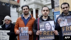 Campaigners hold posters of jailed British-Iranian woman Nazanin Zaghari-Ratcliffe at the Iranian Embassy in London on February 21, 2018.