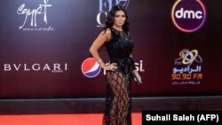FILE - Egyptian actress Rania Youssef poses on the red carpet at the closing ceremony of the 40th edition of the Cairo International Film Festival (CIFF) at the Cairo Opera House in the Egyptian capital, Nov. 29, 2018.