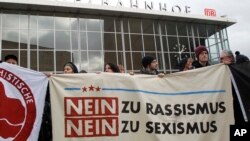 People protest in front of the main station in Cologne, Germany, on Wednesday, Jan. 6, 2016.