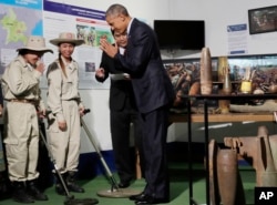 U.S. President Barack Obama greets workers in a tour displaying tools used to clear land of unexploded ordnance at the Cooperative Orthotic and Prosthetic Enterprise (COPE) Visitor Centre in Vientiane, Laos, Wednesday, Sept. 7, 2016.