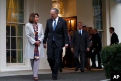 House Democratic leader Nancy Pelosi of California, left, walks with Senate Minority Leader Chuck Schumer, D-N.Y., as Democratic leaders including Sen. Dick Durbin, D-Ill., at right, arrive to speak to the media after meeting with President Donald Trump, Jan. 2, 2018, at the White House.
