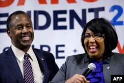 Candy Carson, at right, joins her husband Republican presidential candidate Ben Carson, at left, on stage during a town hall meeting, Feb. 21, 2016, in Reno, Nev.