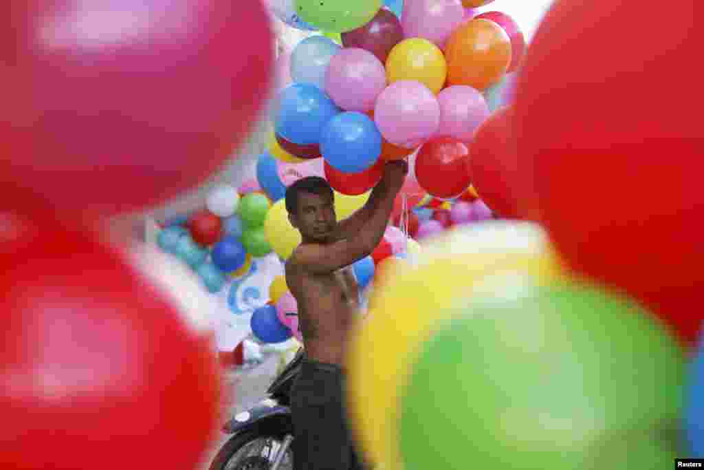 A man prepares balloons for supporters of the Cambodian People Party during an election rally on the last day of campaigning in central Phnom Penh. Cambodia will hold general elections on July 28. 