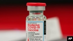 Vial of the Moderna COVID-19 vaccine in the first round of staff vaccinations at a hospital in Denver. On Thursday, Oct. 14, 2021, U.S. health advisers said that some Americans who received Moderna’s COVID-19 vaccine should get a half-dose booster to bolster protection