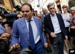 Democratic Party members Andrea Marcucci, left, group leader at the Italian Senate and Graziano Delrio group leader at the Lower Chamber walk in Rome, April 24, 2018.