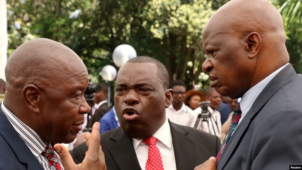 Zimbabwean President Emmerson Mnangagwa's advisor Chris Mutsvangwa talks to Foreign Affairs minister Sibusiso Moyo and Finance Minister Patrick Chinamasa at State House in Harare, Zimbabwe Dec. 4, 2017. 