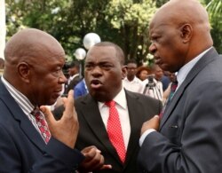 FILE: Zimbabwean President Emmerson Mnangagwa's advisor Chris Mutsvangwa talks to Foreign Affairs minister Sibusiso Moyo and Finance Minister Patrick Chinamasa at State House in Harare, Zimbabwe Dec. 4, 2017.