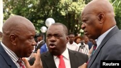 FILE: Zimbabwean President Emmerson Mnangagwa's advisor Chris Mutsvangwa talks to Foreign Affairs Minister Sibusiso Moyo and Finance Minister Patrick Chinamasa at State House in Harare, Zimbabwe Dec. 4, 2017. 