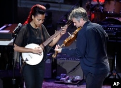 Rhiannon Giddens, left, performs with Dirk Powell during the Americana Honors and Awards awards show, Sept. 13, 2017, in Nashville, Tennessee.