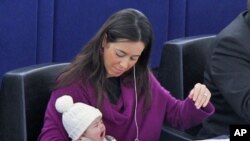 Italy's Member of the European Parliament Licia Ronzulli takes part with her baby in a voting session at the European Parliament in Strasbourg December 16, 2010
