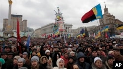 Pro-European Union activists attend a rally in Independence Square in Kiev, Ukraine, Sunday, Jan. 12, 2014. Tens of thousands of activists rallied in the center of the Ukrainian capital on Sunday, while the organizers of the weeks-long anti-government pro