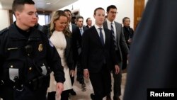 Facebook CEO Mark Zuckerberg walks to a meeting with Senator John Thune (R-SD) on Capitol Hill in Washington, April 9, 2018. 