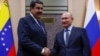 FILE PHOTO: Russian President Vladimir Putin, right, shakes hands with his Venezuelan counterpart Nicolas Maduro during a meeting at the Novo-Ogaryovo state residence outside Moscow, Russia Dec. 5, 2018. 