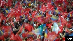 Supporters wave flags as Turkish President speaks during a pre-election rally in Sarajevo, on May 20, 2018.