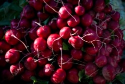 FILE - Radishes are displayed for sale at an outdoor market in Arlington, Va., May 24, 2014. (AP Photo/J. Scott Applewhite)