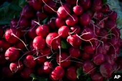FILE - Radishes are displayed for sale at an outdoor market in Arlington, Va., May 24, 2014. (AP Photo/J. Scott Applewhite)