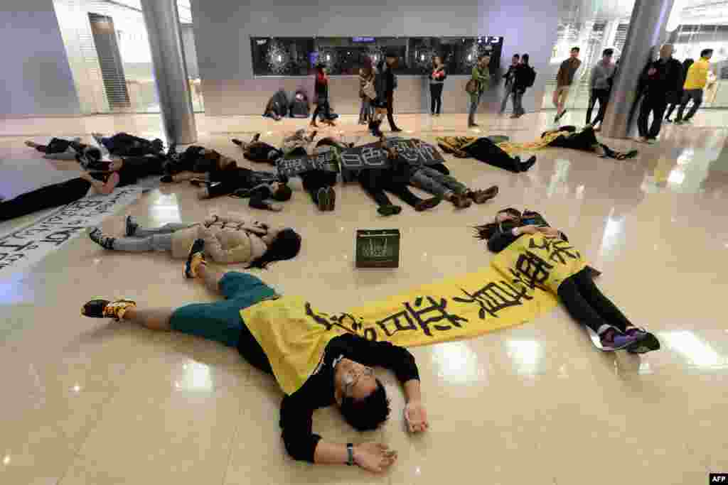 A small group of pro-democracy protesters stage a "die-in" flash mob in a luxurious Hong Kong shopping mall, calling for true universal suffrage for the city in 2017.