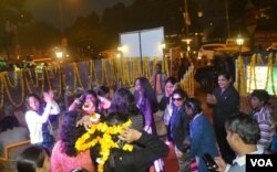 The young women and girls dance and sing to celebrate two years that have ended their isolation and helped them lead normal lives. (A. Pasricha for VOA)