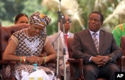 FILE - Zimbabwean then-first lady Grace Mugabe (L) sits next to Emmerson Mnangagwa at the ZANU-PF headquarters in Harare, Feb, 10, 2016.