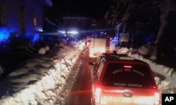 Firefighters vehicles make their way to the hotel hit by an avalanche in Farindola, Italy, Jan. 19, 2017.