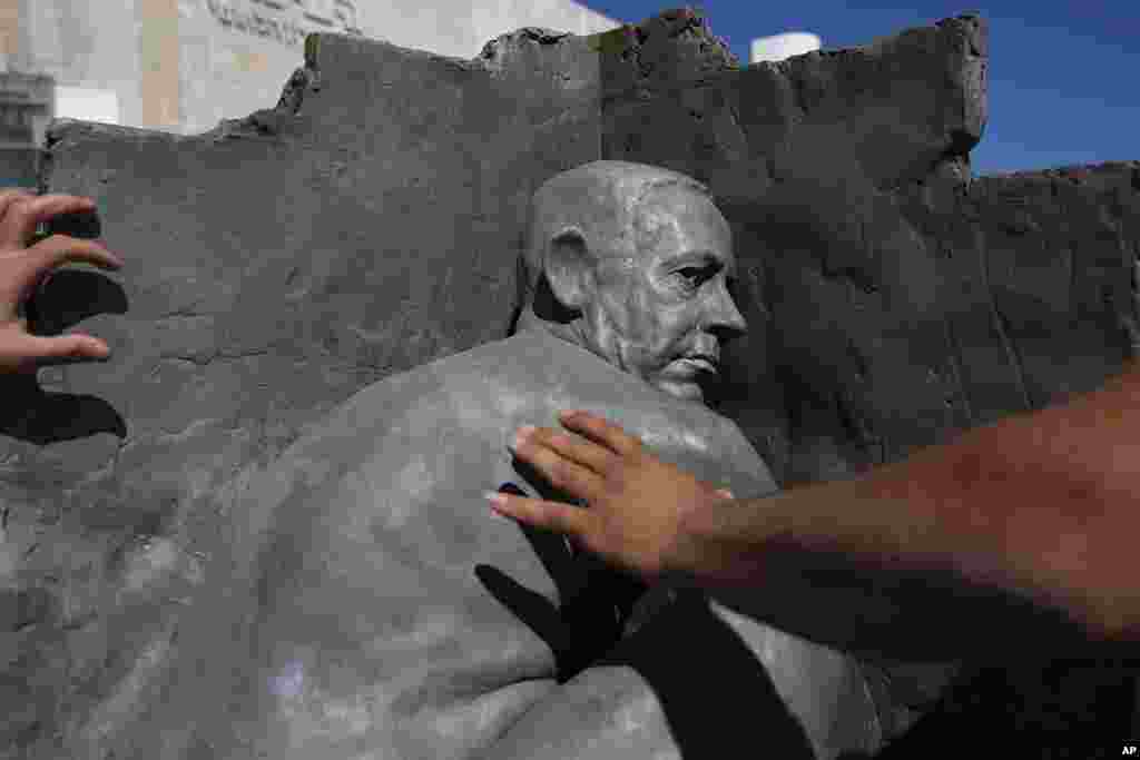 Tel Aviv municipality workers remove a statue by an unidentified artist depicting Israeli Prime Minister Benjamin Netanyahu naked, in Habima Square, Tel Aviv, Israel.
