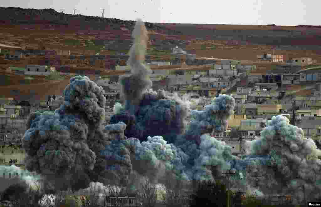 An explosion following an airstrike is seen in Kobani, from near the Mursitpinar border crossing on the Turkish-Syrian border in the southeastern town of Suruc in Sanliurfa province, Nov. 2, 2014. 