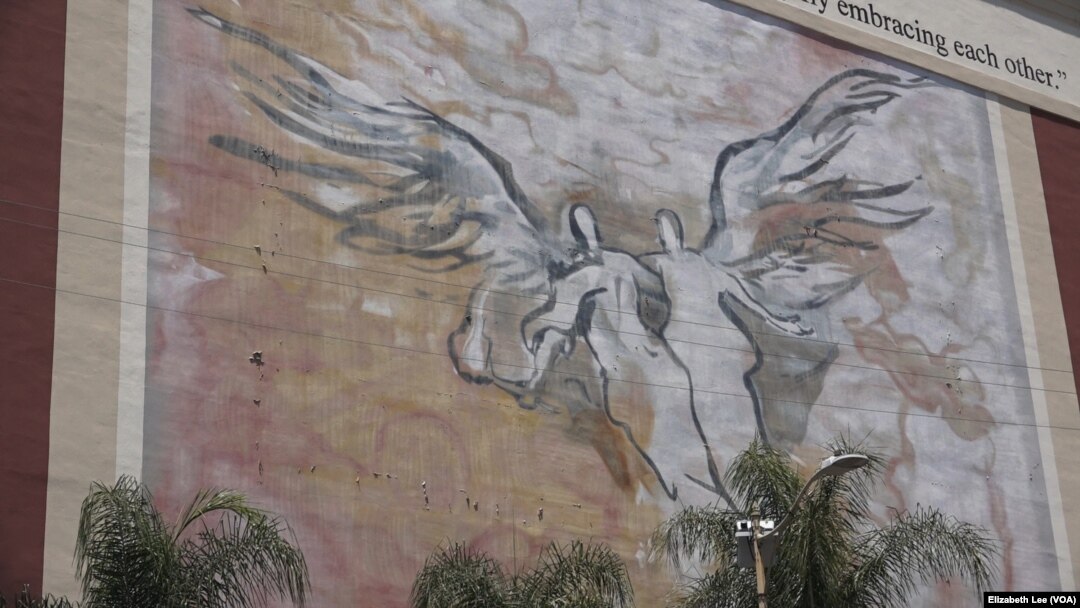 The Byzantine-Latino Quarter mural is directly across the street from St. Sophia Greek Orthodox Cathedral. The neighborhood is in Los Angeles just west of downtown. The orthodox church sits next to a Catholic church.