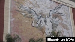 The Byzantine-Latino Quarter mural is directly across the street from St. Sophia Greek Orthodox Cathedral. The neighborhood is in Los Angeles just west of downtown. The orthodox church sits next to a Catholic church.