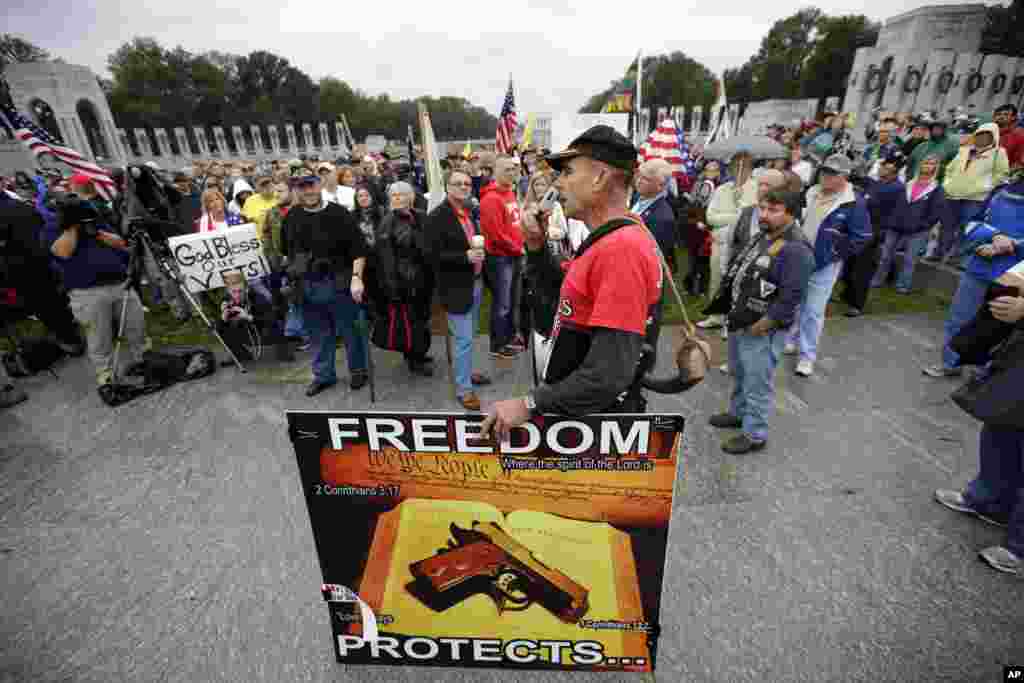 A protester speaks to people gathered at a rally at the World War II Memorial in Washington, Oct. 13, 2013. 
