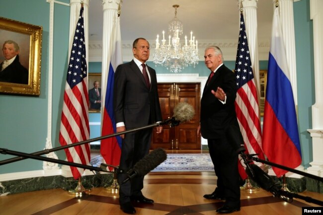 U.S. Secretary of State Rex Tillerson (R) waves to the media next to Russian Foreign Minister Sergey Lavrov before their meeting at the State Department in Washington, May 10, 2017.