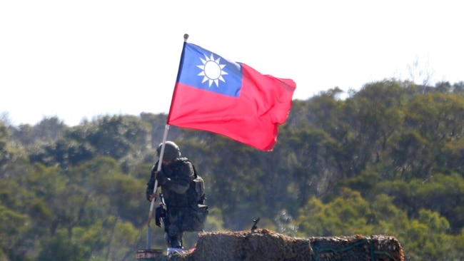 FILE - A soldier holds a Taiwanese flag during a military exercise aimed at repelling an attack from China in Hsinchu County, northern Taiwan, Jan. 19, 2021.