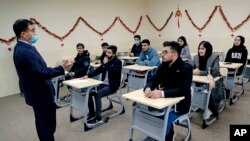Chinese lecturer Zhiwei Hu speaks to students in the Chinese language department at Salahaddin University in Irbil, Iraq, Jan. 19, 2021.