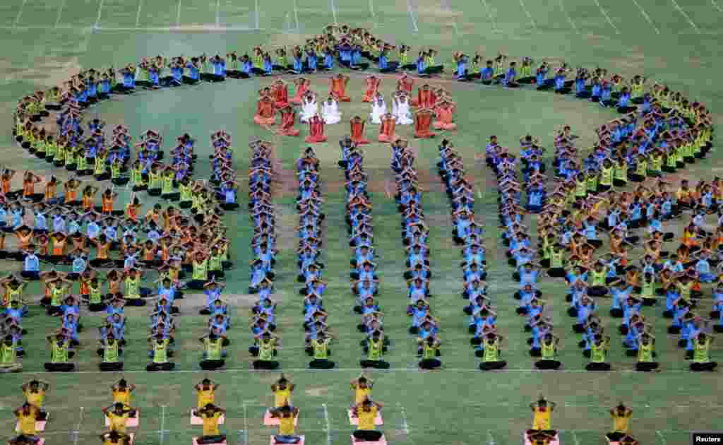 Students perform yoga during a full dress rehearsal ahead of World Yoga Day in Ahmedabad, India.